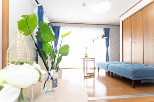 a living room with a blue couch and a window at Yokkaichi - House - Vacation STAY 68045v in Yokkaichi