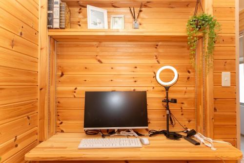 a desk with a computer on a wooden wall at Yokkaichi - House - Vacation STAY 68045v in Yokkaichi