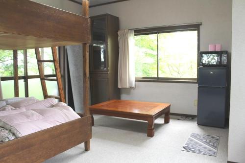 a bedroom with a bed and a table and a window at Washinosu Campground - Vacation STAY 85295v in Motegi