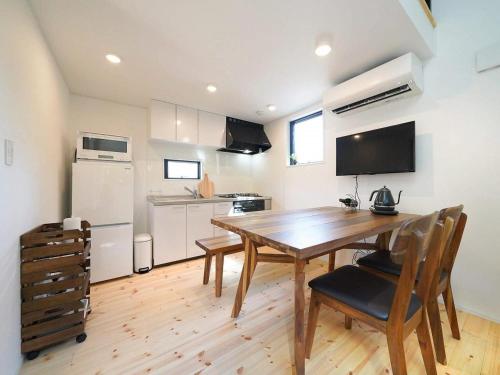 a kitchen with a wooden table and a dining room at SENKO TINY CAMP - Vacation STAY 34705v in Ueda