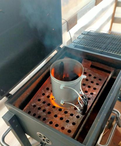 a pot is cooking on a grill with smoke at Glamping nijo in Itoshima - Vacation STAY 71943v in Itoshima