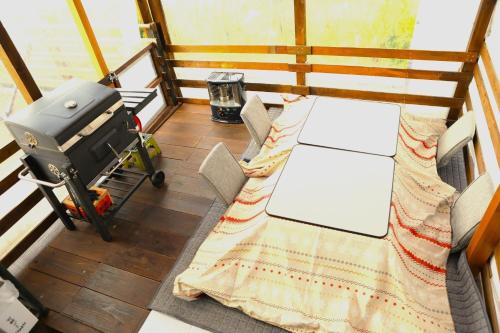 a small room with a table and a grill at Glamping nijo in Itoshima - Vacation STAY 71943v in Itoshima
