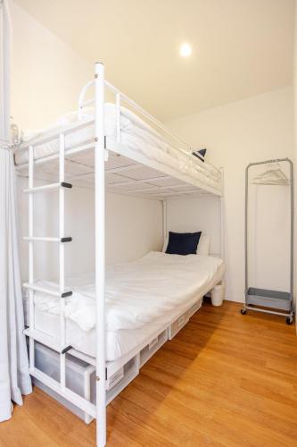 a bedroom with a white bunk bed and a mirror at Turf and Surf Taito Beach - Vacation STAY 76598v in Isumi