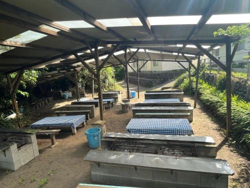 a row of tables and benches in a garden at Yotsubaso Bungalow Village - Vacation STAY 85279v in Moriya