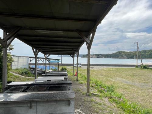 a pavilion with a view of the beach and the ocean at Yotsubaso Bungalow Village - Vacation STAY 85279v in Moriya