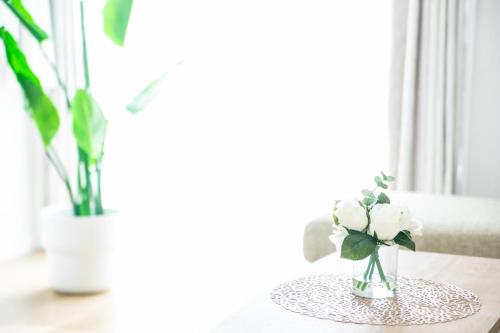 a table with a vase with flowers on it at ナガシマリバーサイドリゾート - Vacation STAY 94113v in Kuwana