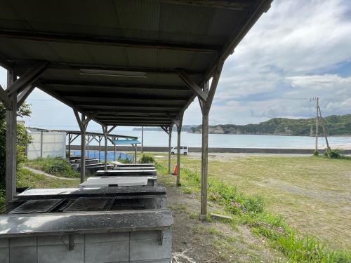 a pavilion at the beach with the ocean in the background at Yotsubaso Bungalow Village - Vacation STAY 85281v in Moriya