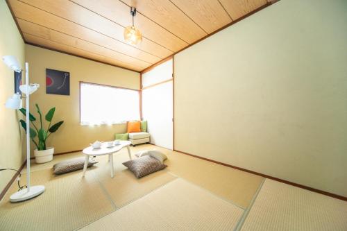 a living room with a table and a chair at ナガシマリバーサイドリゾート - Vacation STAY 94113v in Kuwana