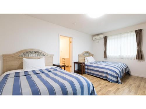 a hotel room with two beds and a window at TEA TREES - Vacation STAY 86532v in Tateyama