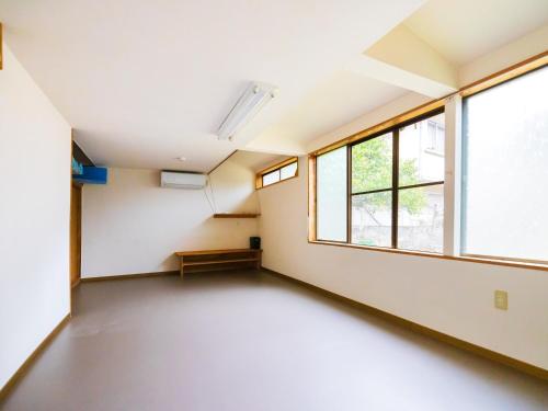an empty room with windows in a building at Goenza OYADO - Vacation STAY 86611v in Takinohai