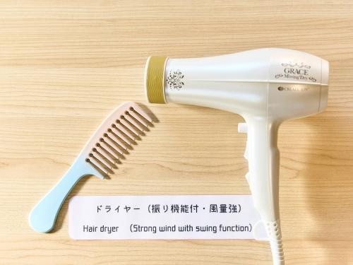 a hair brush sitting on top of a wooden table at Kokoyui Guest House Shingu - Vacation STAY 03207v in Shingu