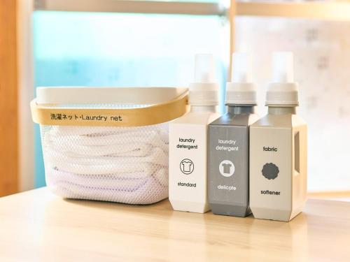 a group of three bottles of laundry detergent and towels at Kokoyui Guest House Shingu - Vacation STAY 03207v in Shingu