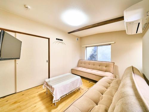 a living room with a couch and a flat screen tv at Kokoyui Guest House Shingu - Vacation STAY 03207v in Shingu