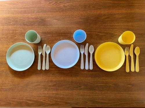 a table with plates and utensils on a table at Kokoyui Guest House Shingu - Vacation STAY 03207v in Shingu