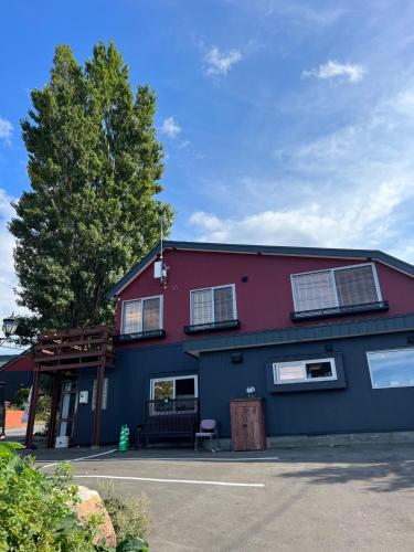 a red and blue building with a bench in front of it at Populus-club Otaru - Vacation STAY 93686v in Otaru