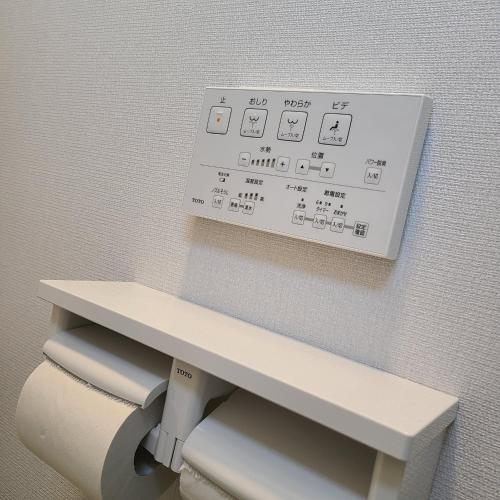 a bench in a bathroom with a white wall at Fluctus - Vacation STAY 16974v in Hitachi