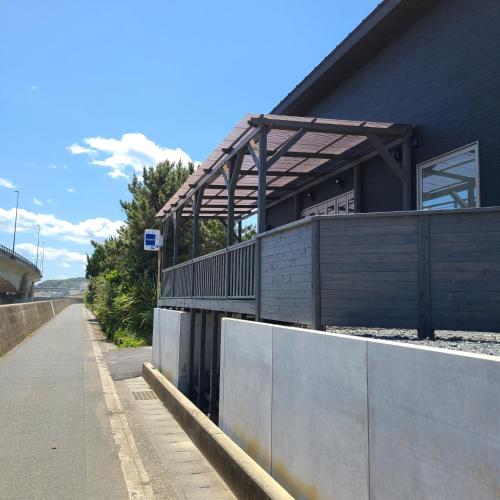 a building with a fence next to a road at Fluctus - Vacation STAY 16974v in Hitachi