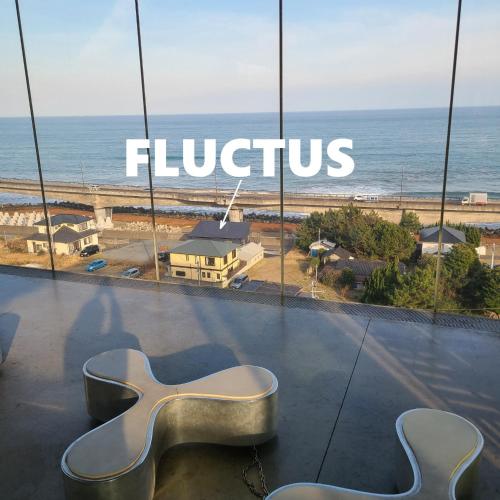 a view of the ocean from a store window with a guitar seat at Fluctus - Vacation STAY 16974v in Hitachi