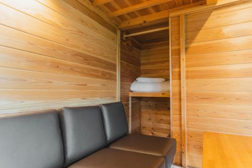 a couch in a room with wood paneling at Mahora Inahoyama - Vacation STAY 18660v in Minano