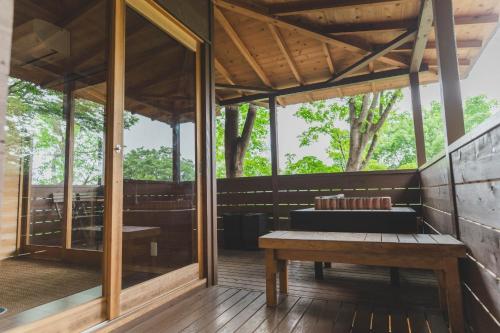 a wooden porch with a bench on a deck at Mahora Inahoyama - Vacation STAY 18660v in Minano