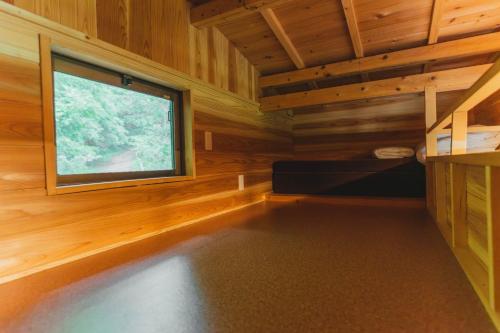 a room with a large window in a log cabin at Mahora Inahoyama - Vacation STAY 18660v in Minano