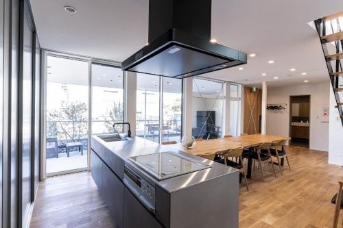 a kitchen with a wooden table and a counter top at nabe cape - Vacation STAY 04217v in Tagawa