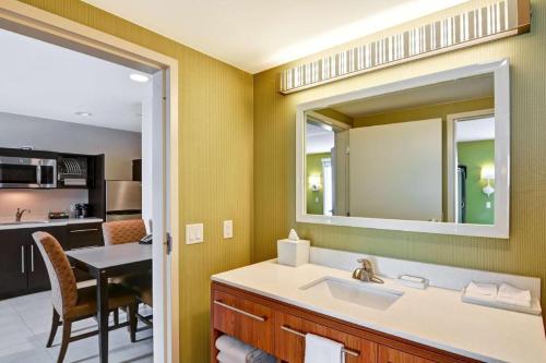 a bathroom with a sink and a mirror at Home2 Suites by Hilton Green Bay in Green Bay
