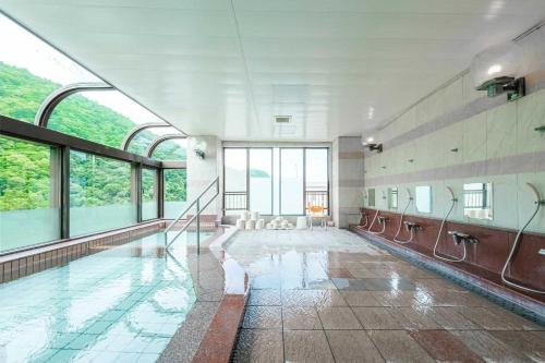 a swimming pool in a building with windows at Lions Mansion Sanbankan Room 506 - Vacation STAY 14364 in Jozankei