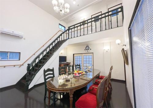 a dining room with a table and a staircase at holiday house shirahama - Vacation STAY 19040v in Kanayama