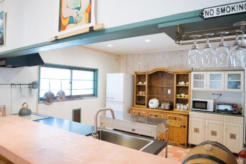 a large kitchen with a sink and a counter at Sun Terrace Bessho Onsen - Vacation STAY 21387v in Ueda