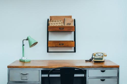 a desk with a lamp and a phone on it at La Joya Hostel in Valparaíso