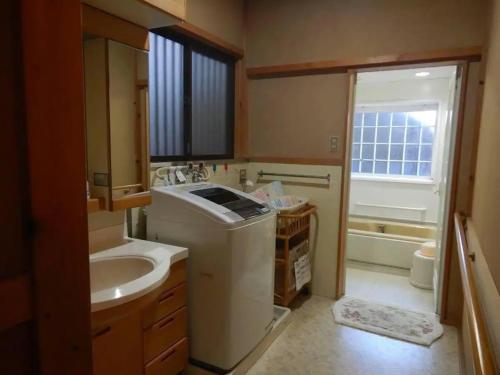a bathroom with a sink and a toilet and a tub at private villa Gifutakayama - Vacation STAY 26633v in Takayama