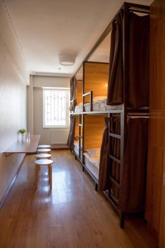 a room with bunk beds and a table at Eternal Sky Tour & Guest house in Ulaanbaatar