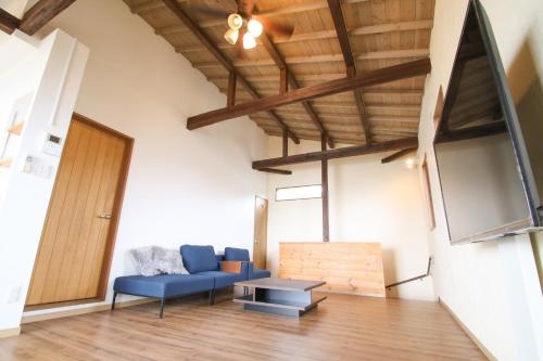 a living room with a blue couch and a table at yunoya-yunoya- - Vacation STAY 14457 in Amami