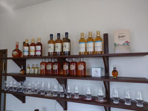 a bunch of wine bottles and glasses on shelves at Abashirikai no Taiyo - Vacation STAY 14558 in Abashiri