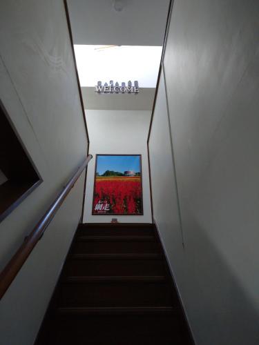 a stairway with a picture of a red flower at Abashirikai no Taiyo - Vacation STAY 14558 in Abashiri