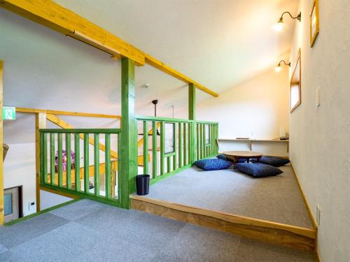 a room with green and white walls and a table at Country Cottage Waki Aiai - Vacation STAY 26548v in Sorachi