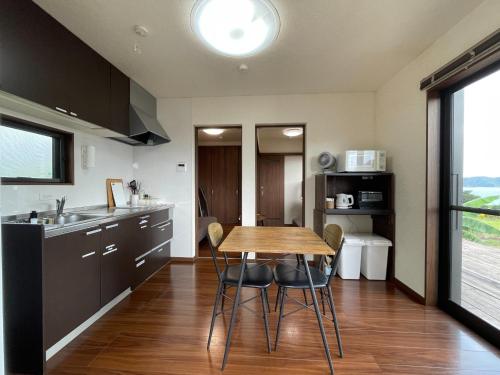 a kitchen with a wooden table and chairs at On the hill ! ashitoku2 - Vacation STAY 14430 in Akaoki