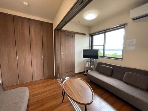 a living room with a couch and a tv at On the hill ! ashitoku2 - Vacation STAY 14430 in Akaoki