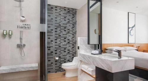 a bathroom with a sink and a toilet and a shower at Fairfield by Marriott Baoding High-Tech Zone in Baoding