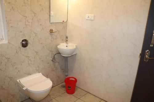 a bathroom with a toilet and a sink at Urban Nest in Salem