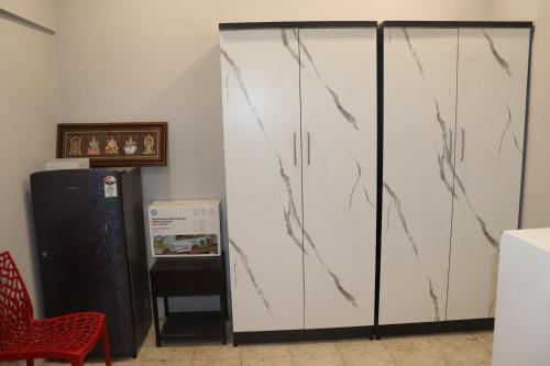 a pair of white cabinets in a room with a red chair at Urban Nest in Salem