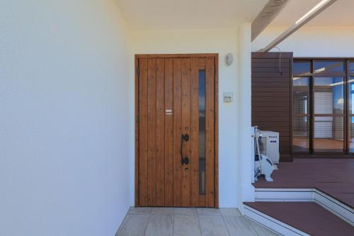 a wooden door on the side of a building at Harbor front JIRAMA 1 - Vacation STAY 14658 in Suno
