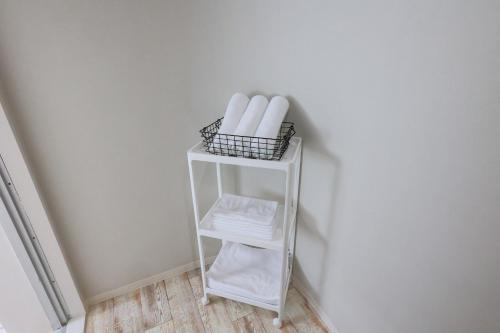 a white shelf with towels and a basket of towels at Harbor front JIRAMA 1 - Vacation STAY 14658 in Suno