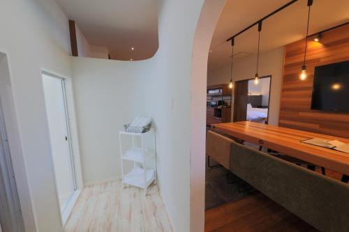 a dining room with a table and a tv at Harbor front JIRAMA 1 - Vacation STAY 14658 in Suno