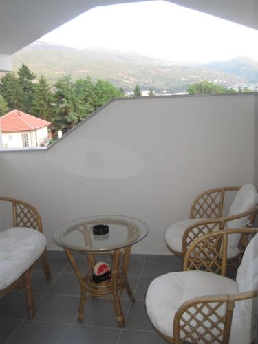 a room with chairs and a table with a view at Villa Jankuloski in Ohrid