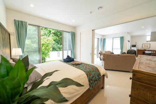 a bedroom with a bed and a living room at kukulu island - Vacation STAY 37864v in Kouri