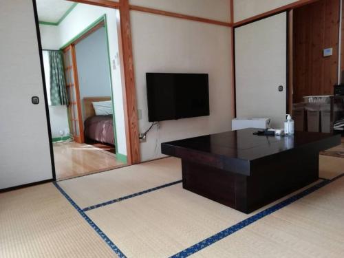 a living room with a table and a television at Polar Resort Nikko3 with DOG - Vacation STAY 43851v in Nikko
