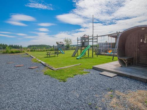 a playground with a slide and a play structure at Luxurious house with sauna in Bastogne in Bastogne
