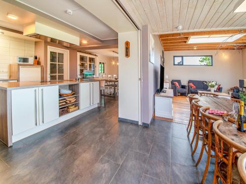 a kitchen and living room with a table and chairs at Luxurious house with sauna in Bastogne in Bastogne